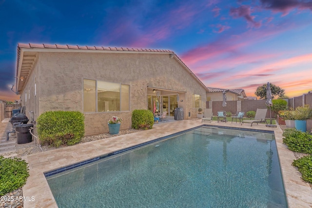 22927 E Via Del Oro, Queen Creek, AZ 85142 - pool at dusk featuring a patio area and a fenced backyard