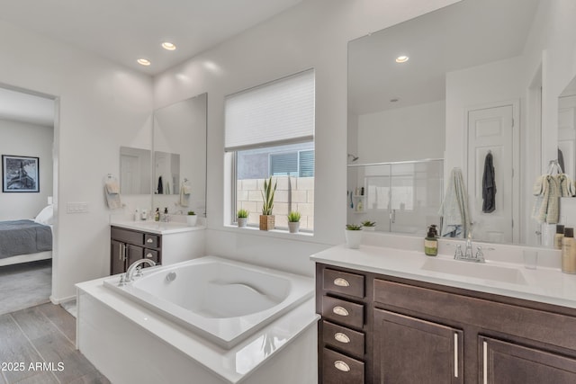 22927 E Via Del Oro, Queen Creek, AZ 85142 - ensuite bathroom with a garden tub, vanity, wood finished floors, an enclosed shower, and recessed lighting