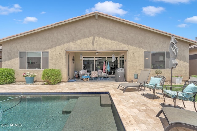 22927 E Via Del Oro, Queen Creek, AZ 85142 - back of property with stucco siding, a patio, and an outdoor pool