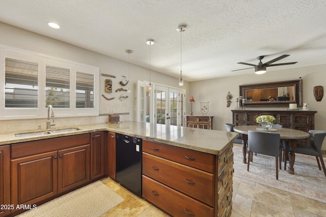 kitchen featuring dishwasher, a peninsula, light stone countertops, french doors, and a sink