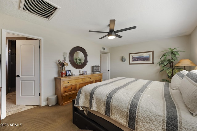 bedroom with carpet, visible vents, and a ceiling fan