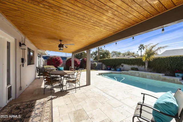 view of patio / terrace with a ceiling fan, outdoor dining area, a fenced backyard, and a fenced in pool