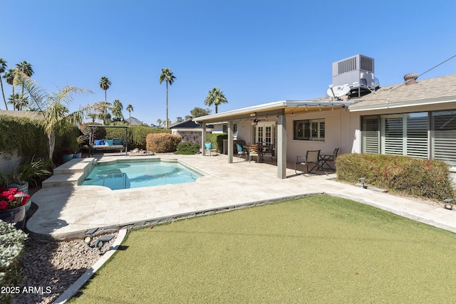 view of swimming pool with a patio area, a fenced backyard, a ceiling fan, and cooling unit