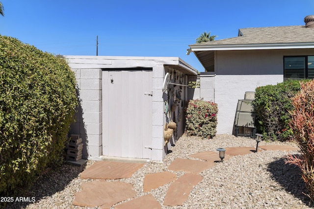 exterior space with an outdoor structure and a shed