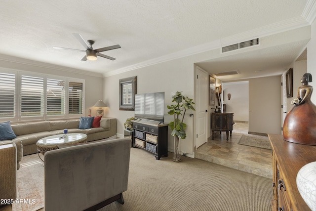 living room featuring ceiling fan, a textured ceiling, light carpet, visible vents, and crown molding