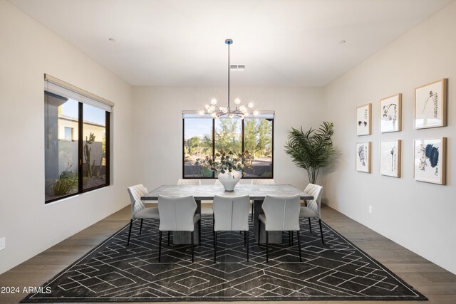 dining space featuring dark hardwood / wood-style floors and a notable chandelier