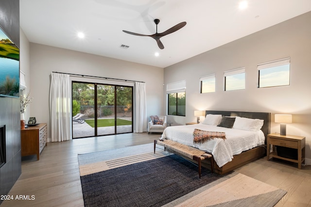 bedroom featuring ceiling fan, access to exterior, and light wood-type flooring