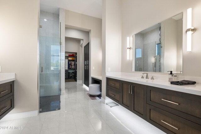 bathroom featuring vanity, tile patterned floors, and walk in shower