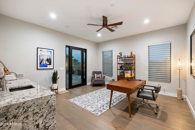 office space featuring sink, ceiling fan, and light wood-type flooring