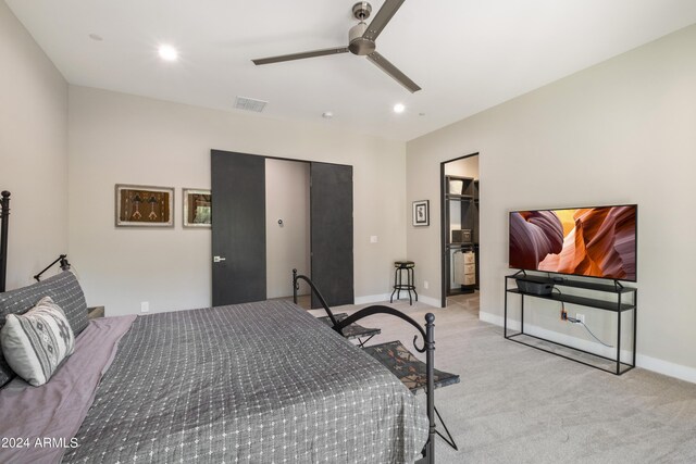 carpeted bedroom featuring ceiling fan and a closet