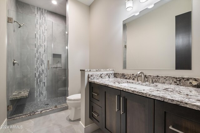 bathroom featuring walk in shower, vanity, and toilet