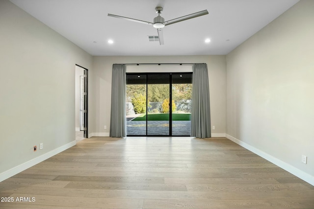 spare room featuring light hardwood / wood-style flooring and ceiling fan