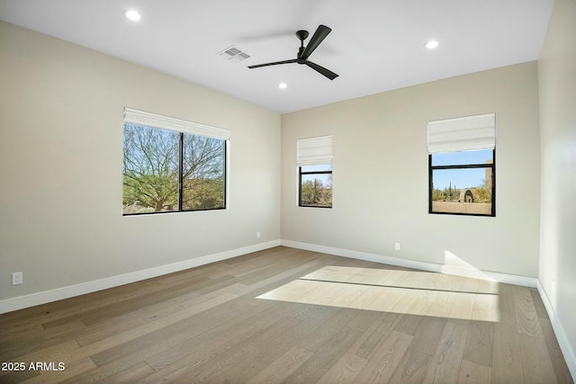 unfurnished room with ceiling fan and light hardwood / wood-style floors