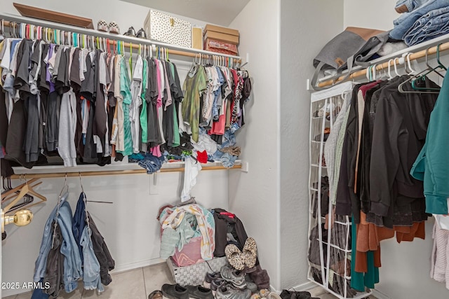 spacious closet featuring tile patterned flooring