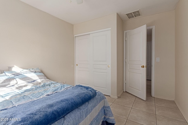 bedroom with a closet and light tile patterned floors