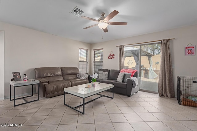 living room featuring ceiling fan, plenty of natural light, and light tile patterned floors