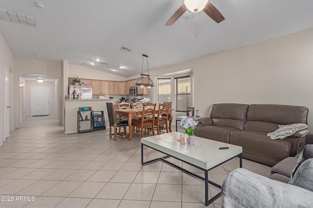 living room with vaulted ceiling, light tile patterned flooring, and ceiling fan