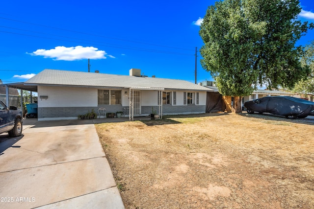 ranch-style home featuring covered porch, concrete driveway, and brick siding