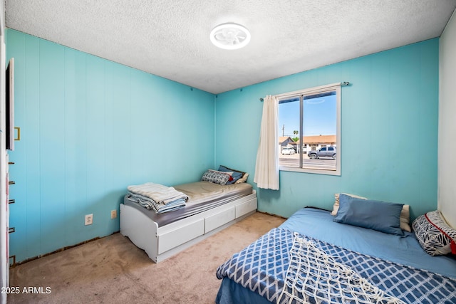 carpeted bedroom featuring a textured ceiling