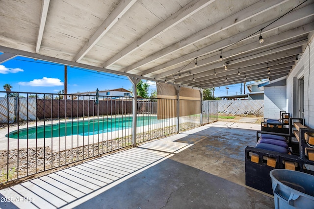 view of swimming pool featuring a fenced backyard and a patio