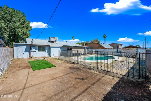 view of pool with a patio area, a fenced backyard, and central AC