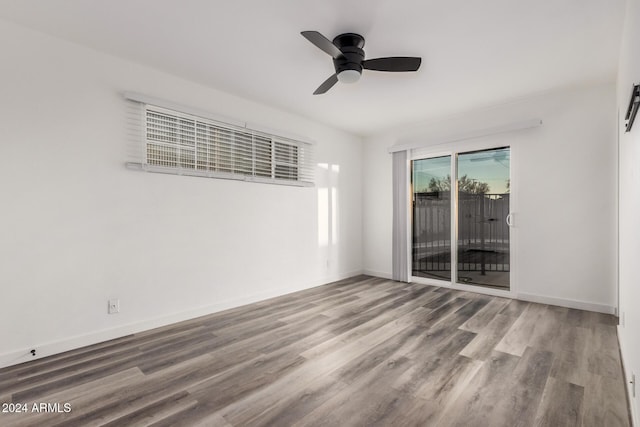 spare room featuring hardwood / wood-style floors and ceiling fan