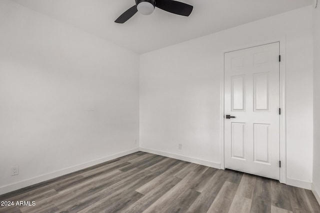 spare room with hardwood / wood-style floors and ceiling fan