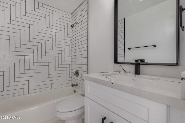 full bathroom with tiled shower / bath combo, toilet, and vanity