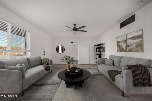 living room featuring hardwood / wood-style floors and ceiling fan