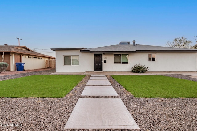 ranch-style house with a front lawn