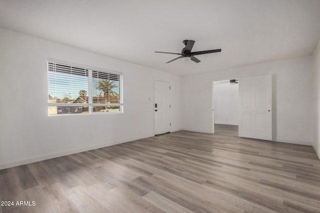 spare room with light wood-type flooring and ceiling fan