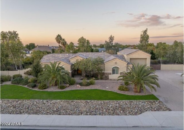 view of front of property with a yard and a garage