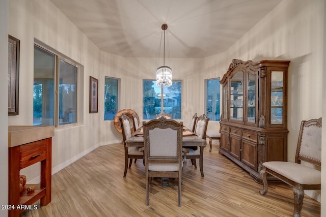 dining room with a chandelier and light hardwood / wood-style floors