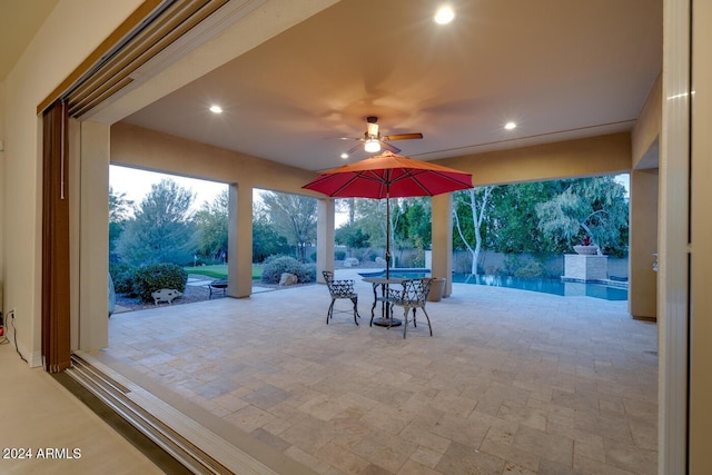 view of patio featuring ceiling fan and a swimming pool