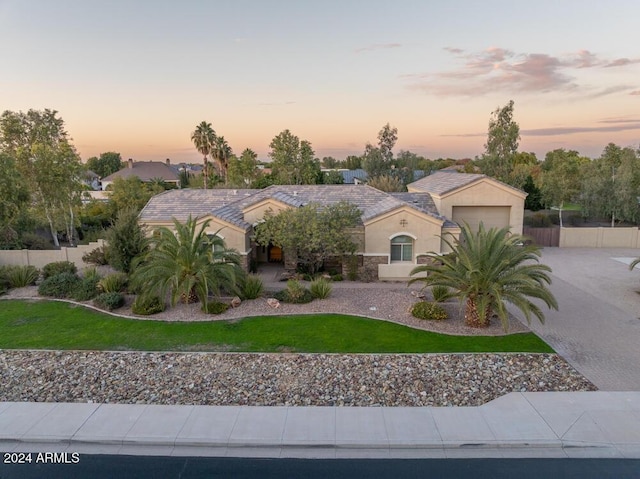 view of front facade featuring a yard and a garage