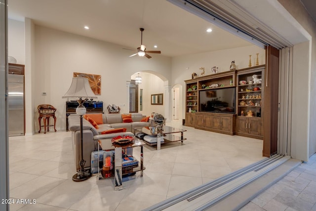 living room featuring ceiling fan and light tile patterned floors