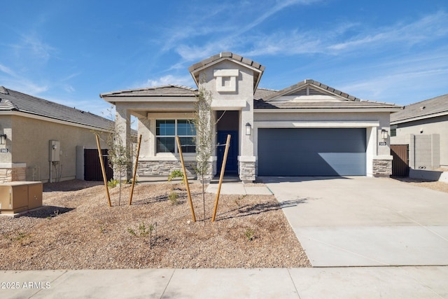 view of front of property with a garage, stone siding, and driveway