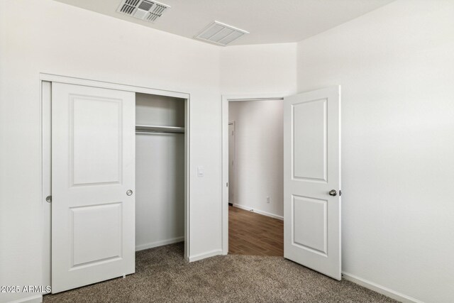 25431 W Graham Trl, Buckeye, AZ 85326 - unfurnished bedroom with visible vents, baseboards, a closet, and carpet flooring