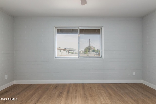 empty room with wood finished floors and baseboards