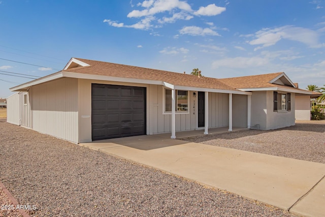 ranch-style house with a garage, concrete driveway, and roof with shingles