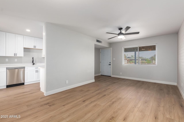 unfurnished living room featuring light wood-type flooring, baseboards, and visible vents