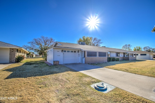 ranch-style home featuring a front lawn and a garage