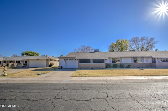 single story home with a garage and a front yard