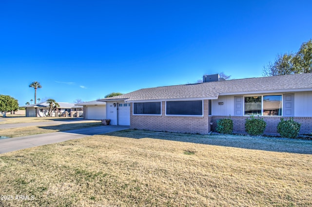 single story home with a garage and a front lawn