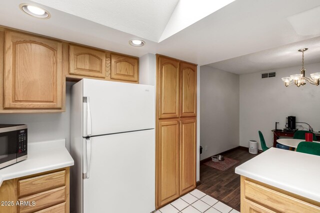 6207 N 21st Dr, Phoenix, AZ 85015 - kitchen featuring stainless steel microwave, recessed lighting, visible vents, light countertops, and freestanding refrigerator