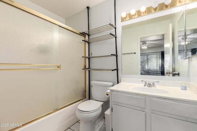 6207 N 21st Dr, Phoenix, AZ 85015 - bathroom featuring combined bath / shower with glass door, ceiling fan, toilet, vanity, and tile patterned flooring
