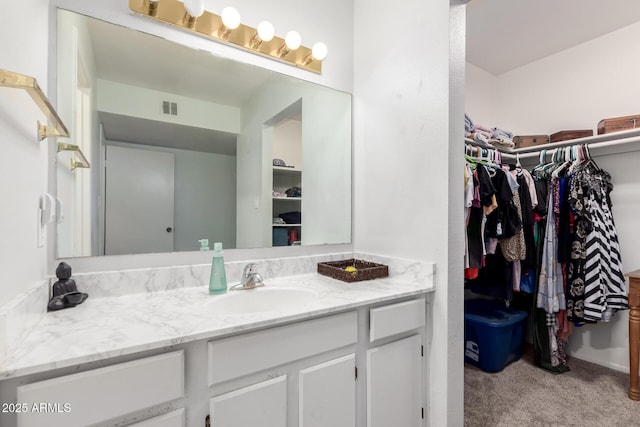 6207 N 21st Dr, Phoenix, AZ 85015 - bathroom with a spacious closet, vanity, and visible vents