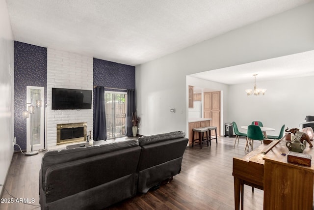 6207 N 21st Dr, Phoenix, AZ 85015 - living area with a fireplace, wood finished floors, and a notable chandelier