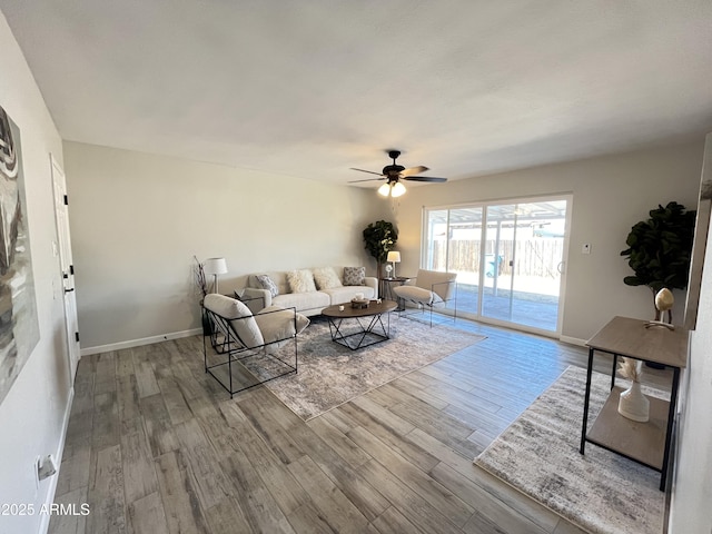 living room featuring wood-type flooring and ceiling fan