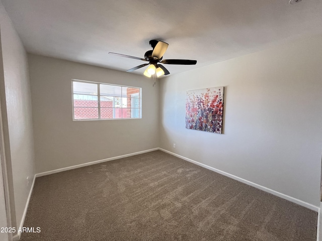 unfurnished room featuring dark colored carpet and ceiling fan